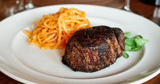 cooked filet with noodles on the side.