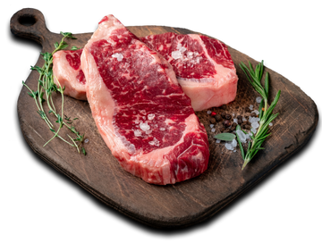 ribeye steaks on a cutting board