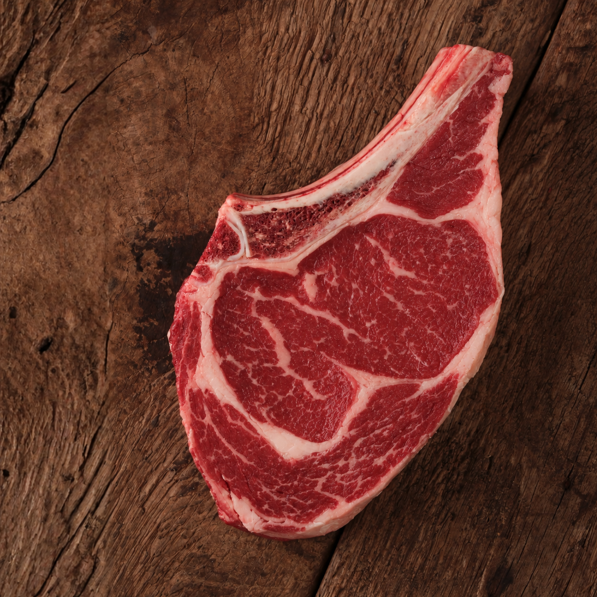 bone in ribeye on a wood cutting board
